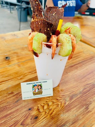 Michelada preparada with shrimp and cucumber